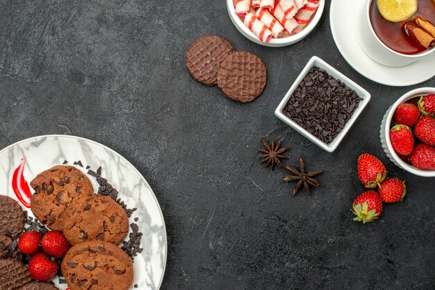 Top view choco biscuits with candies and fruits