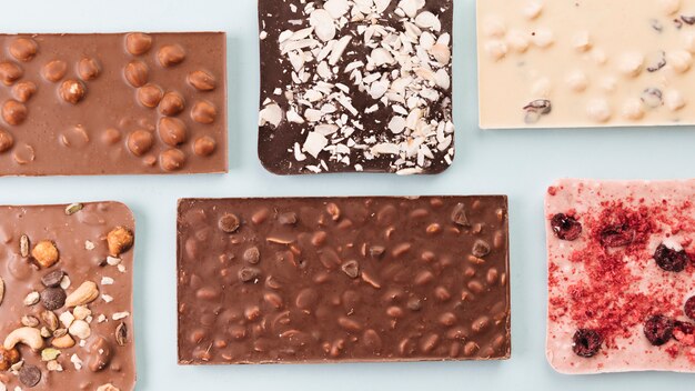 Top view chocolate bars with nuts and berries 