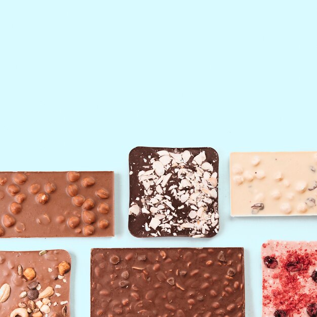 Top view chocolate bars with nuts and berries 