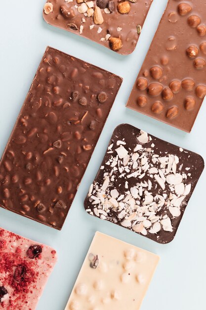 Top view chocolate bars with nuts and berries 