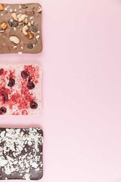 Top view chocolate bars with nuts and berries 