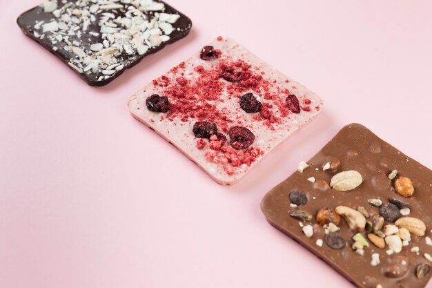 Top view chocolate bars with nuts and berries 