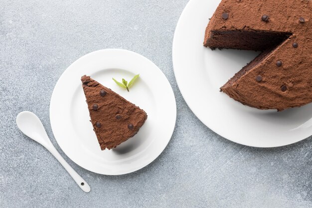 Top view of chocolate cake slice with spoon and mint