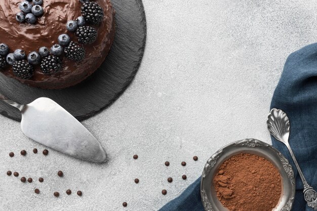 Top view of chocolate cake with blueberries and spatula