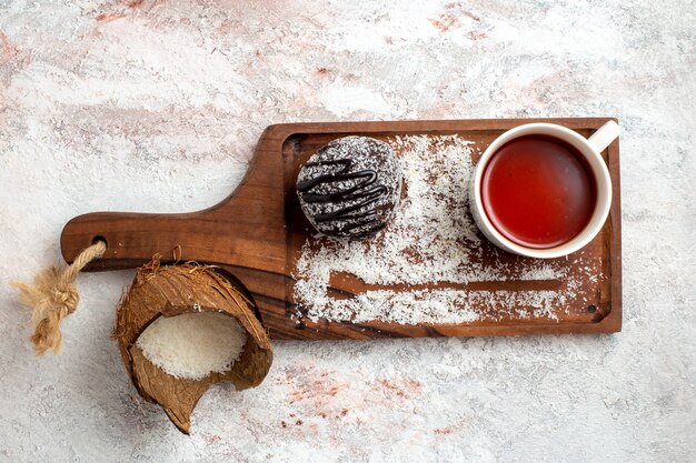 Top view chocolate cake with cup of tea on light white background chocolate cake biscuit sugar sweet cookie