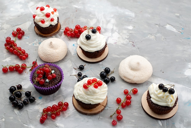 A top view chocolate cakes with donuts cream designed with fruits on the white background cake biscuit donut choco