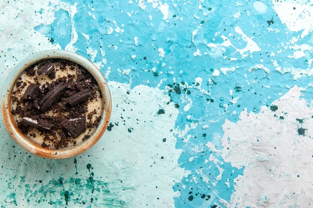 Top view chocolate cookie dessert with cream and cookies inside plate on blue background cake dessert sugar sweet photo