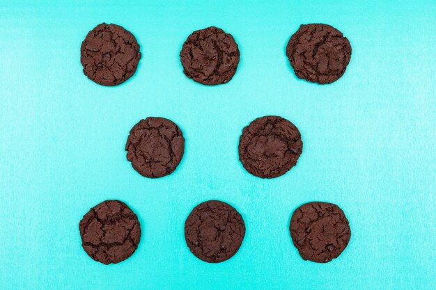 Top view chocolate cookies on blue surface