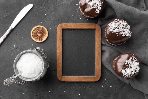 Top view of chocolate desserts with blackboard