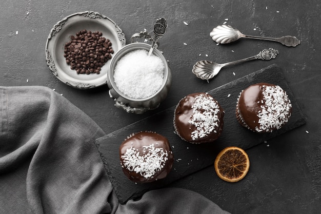 Top view of chocolate desserts with coconut flakes