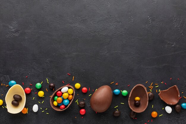 Top view of chocolate easter eggs filled with colorful candy