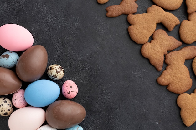 Top view of chocolate easter eggs with bunny shaped cookies