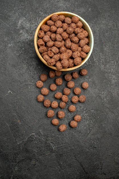 Top view chocolate flakes on dark surface milk meal breakfast cocoa