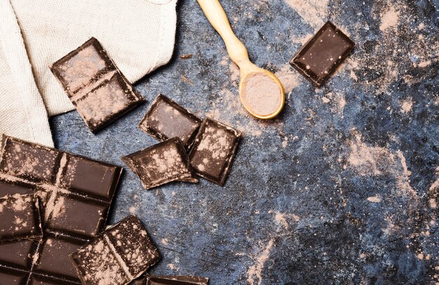 Top view chocolate tablets with cloth and spoon