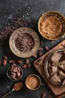 Free photo top view of chocolate with cocoa beans and powder