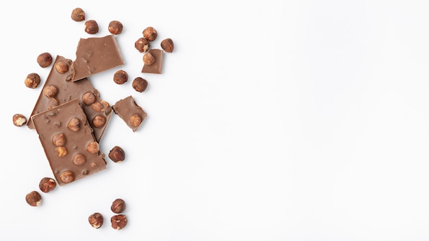 Top view of chocolate with hazelnuts and copy space