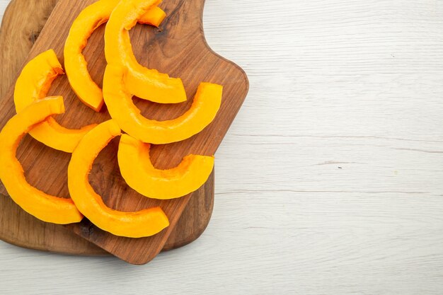 Top view chopped butternut squash on cutting boards on grey table free space