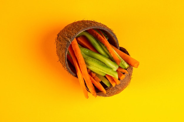 Top view chopped carrots with cucumber in coconut