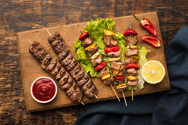 Top view of chopping board with delicious kebab and lemon