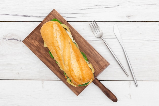 Free photo top view of chopping board with sandwich on top