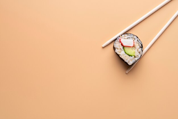 Top view chopsticks holding sushi