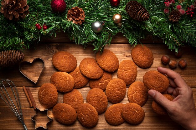 Top view christmas biscuits with wooden background