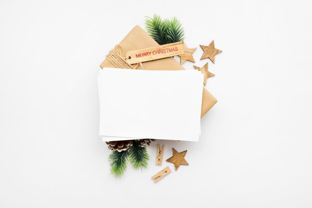 Top view of Christmas composition with gift box, ribbon, fir branches, cones, anise on white table