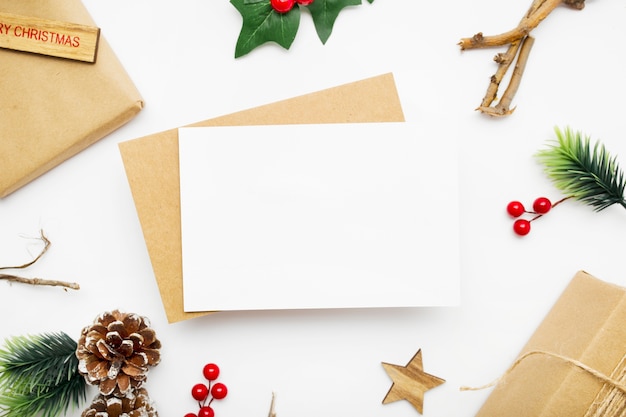 Free photo top view of christmas composition with gift box, ribbon, fir branches, cones, anise on white table