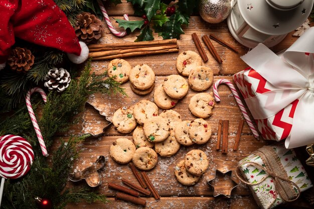 Top view christmas cookies with wooden background