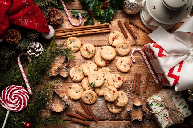 Top view christmas cookies with wooden background