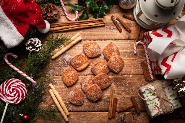 Top view christmas cookies with wooden background