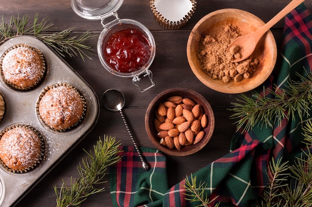 Free photo top view of christmas cupcakes with jam and almonds