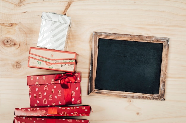 Top view christmas decoration with slate next to presents