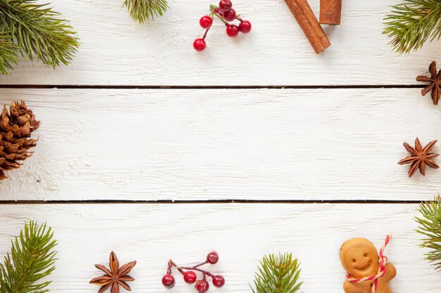 Top view of Christmas decorations and food on a wooden surface with copy space