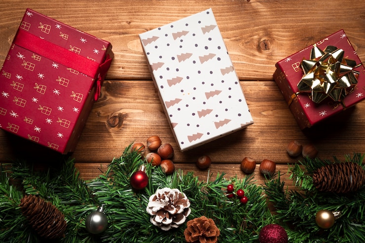Free Photo top view christmas gifts with wooden background
