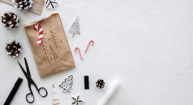 Top view of christmas paper bag with scissors and copy space