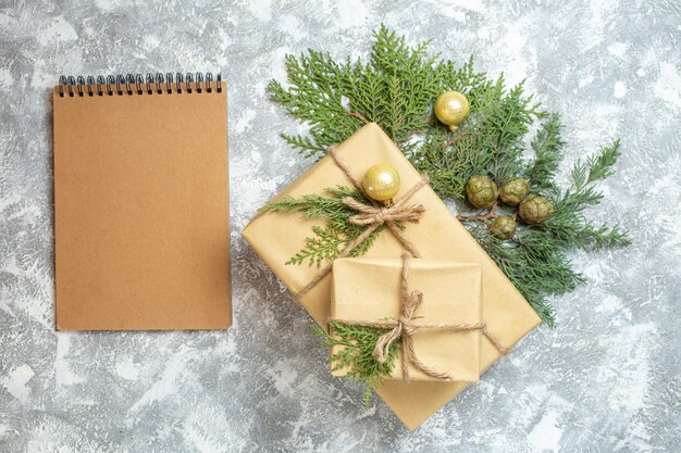 Top view christmas presents with green branch on a white background