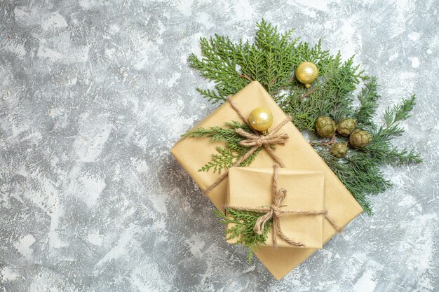 Top view christmas presents with green branch on white background