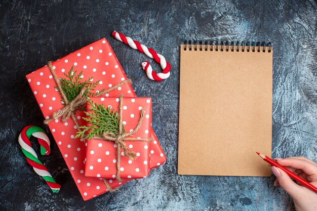 Top view christmas presents with notebook