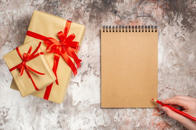 Top view christmas presents with red bow on light background