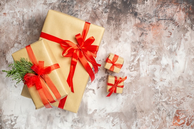 Top view christmas presents with red bow on light background