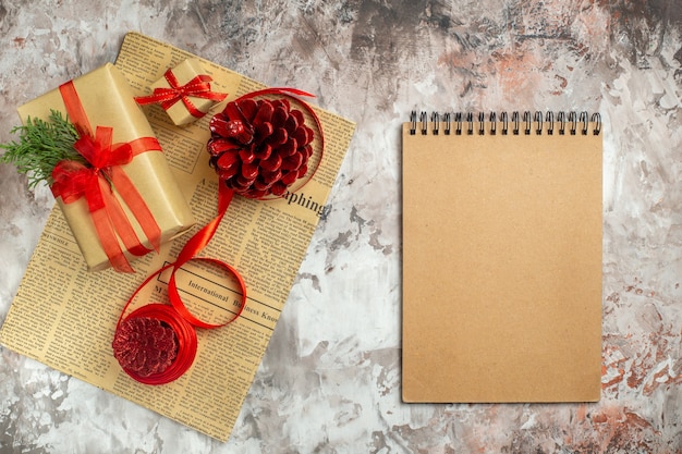 Top view christmas presents with red cones on a light background