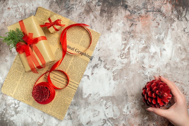 Top view christmas presents with red cones on white background