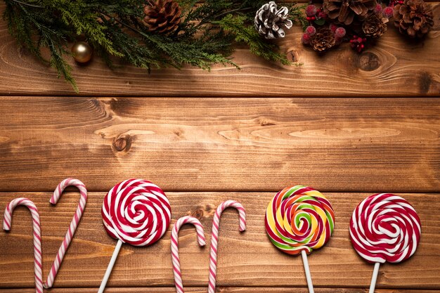 Top view christmas sweets with wooden background