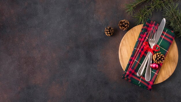 Top view of christmas table arrangement with pine cones and copy space