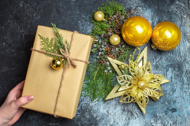 Top view christmas tree toys with gift on light-dark background