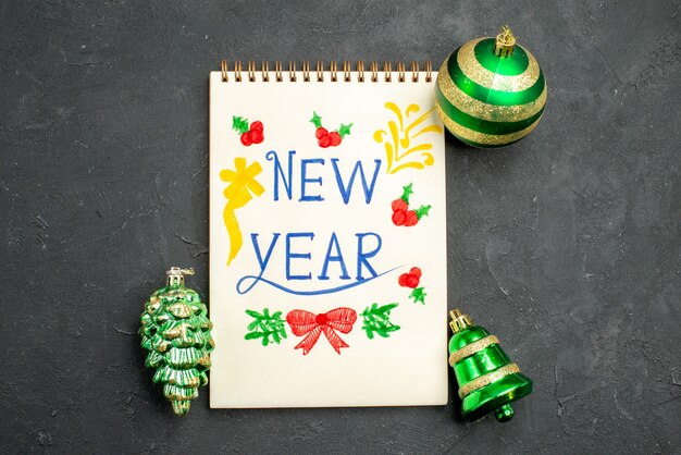 Top view christmas tree toys with new year written notepad