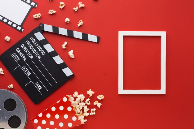 Top view cinema elements on red background with white frame