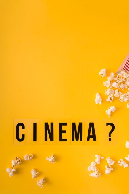 Top view cinema lettering on yellow background with copy space