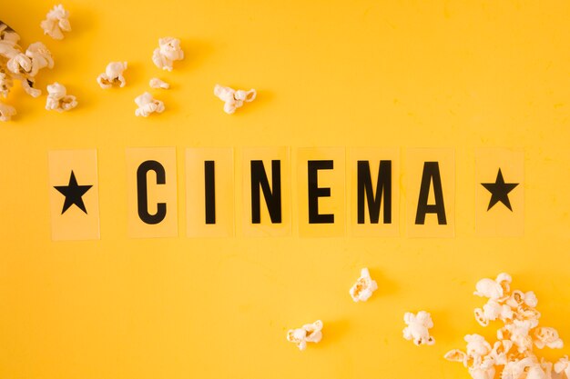 Top view cinema lettering on yellow background